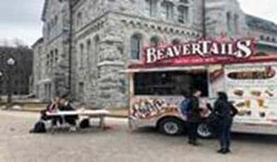 QLIFT students manning the information table on the day of the event, March 28, 2019 at the Beavertails truck on University Avenue Queen’s Campus.