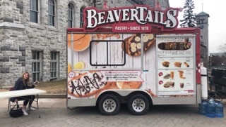 QLIFT students manning the information table on the day of the event, March 28, 2019 at the Beavertails truck on University Avenue Queen’s Campus.